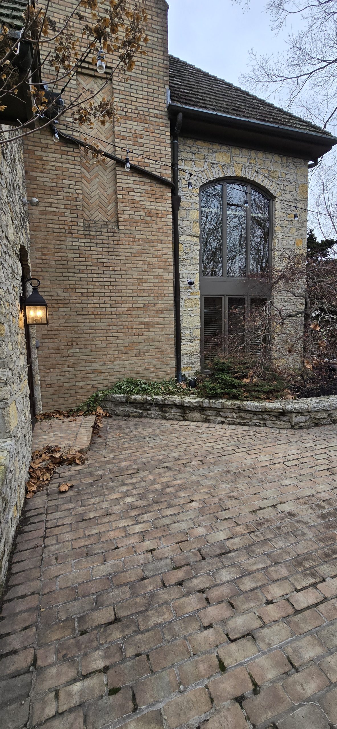 Outdoor security camera on brick wall of house